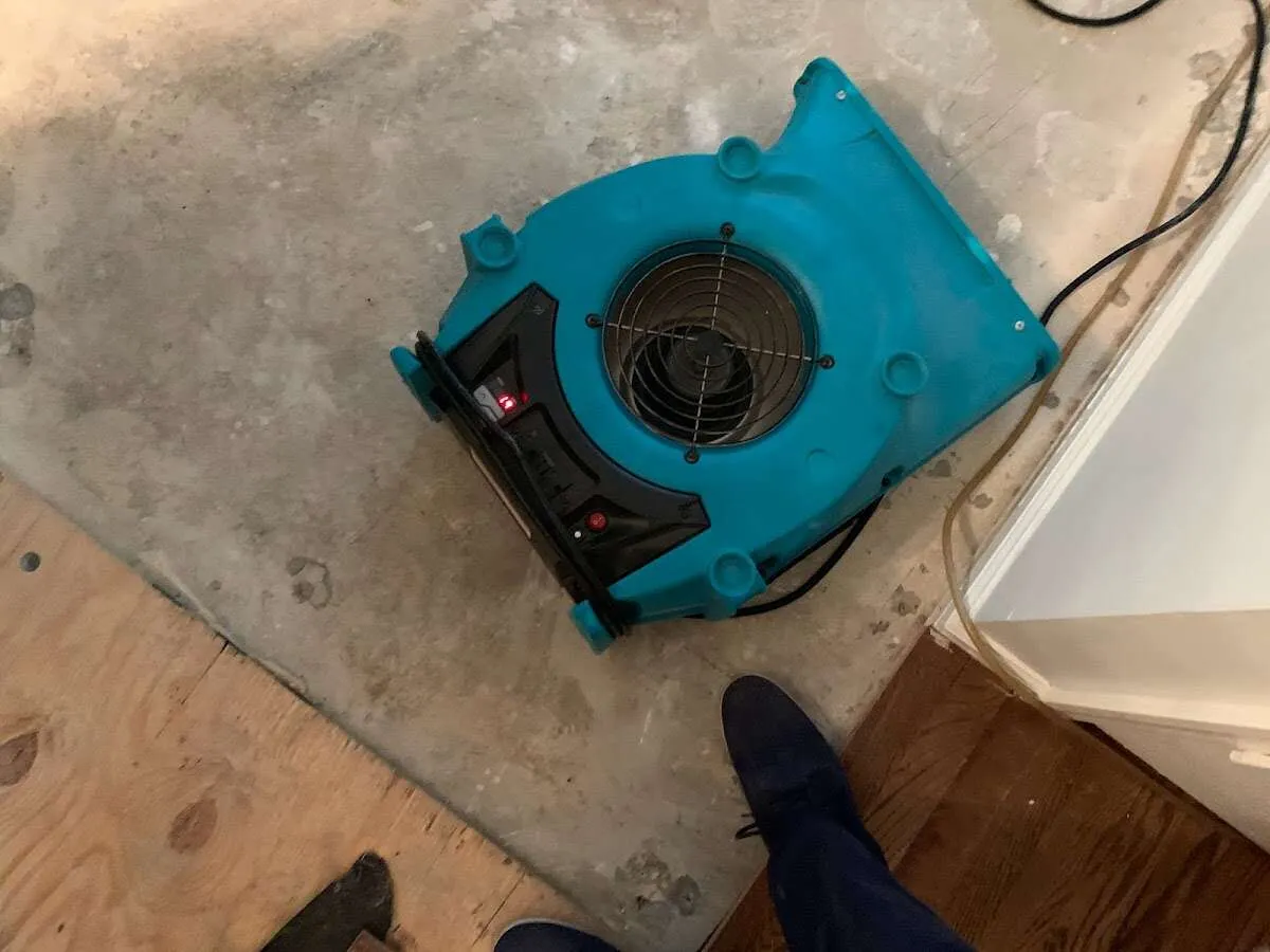 Air mover drying subfloor during Commercial Water Damage Restoration in Bellmawr